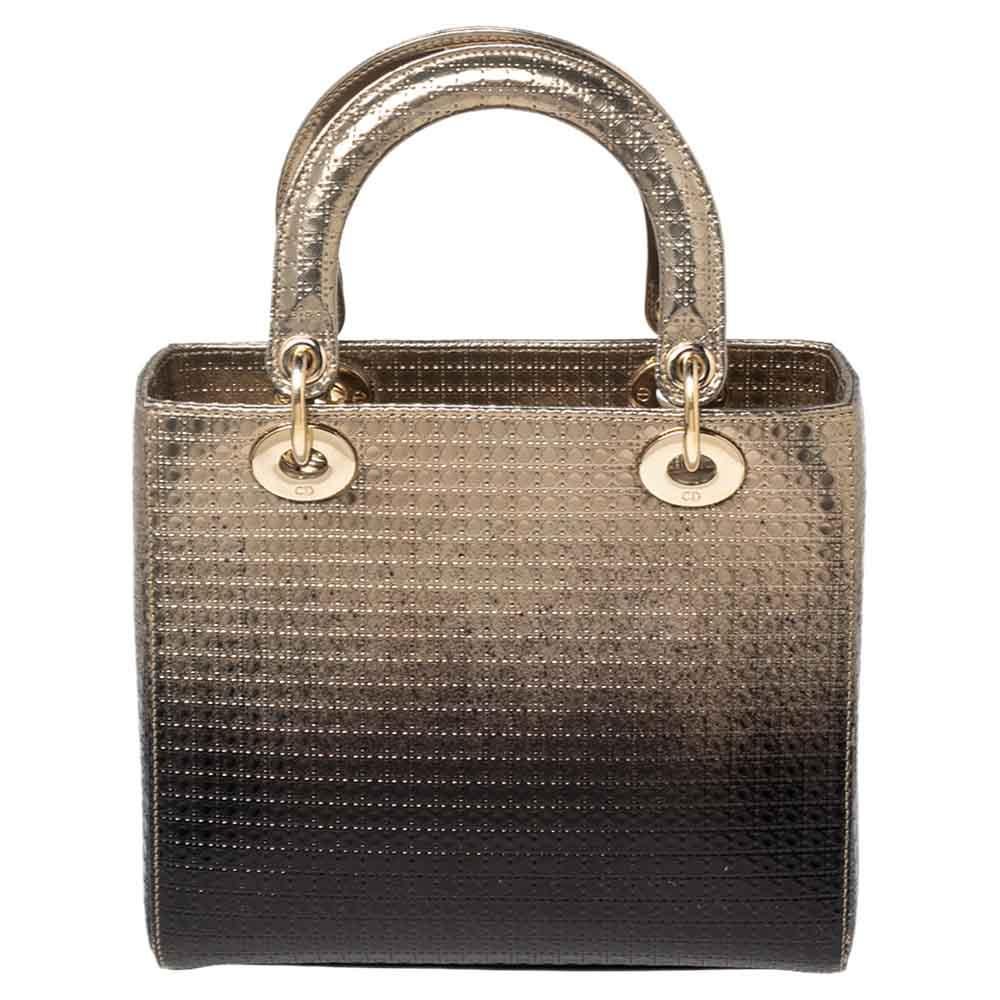 A timeless status and great design mark the Lady Dior tote. It is an iconic bag that people continue to invest in to this day. We have here this classic beauty crafted from metallic ombre gold Microcannage leather. The bag has a lined interior for