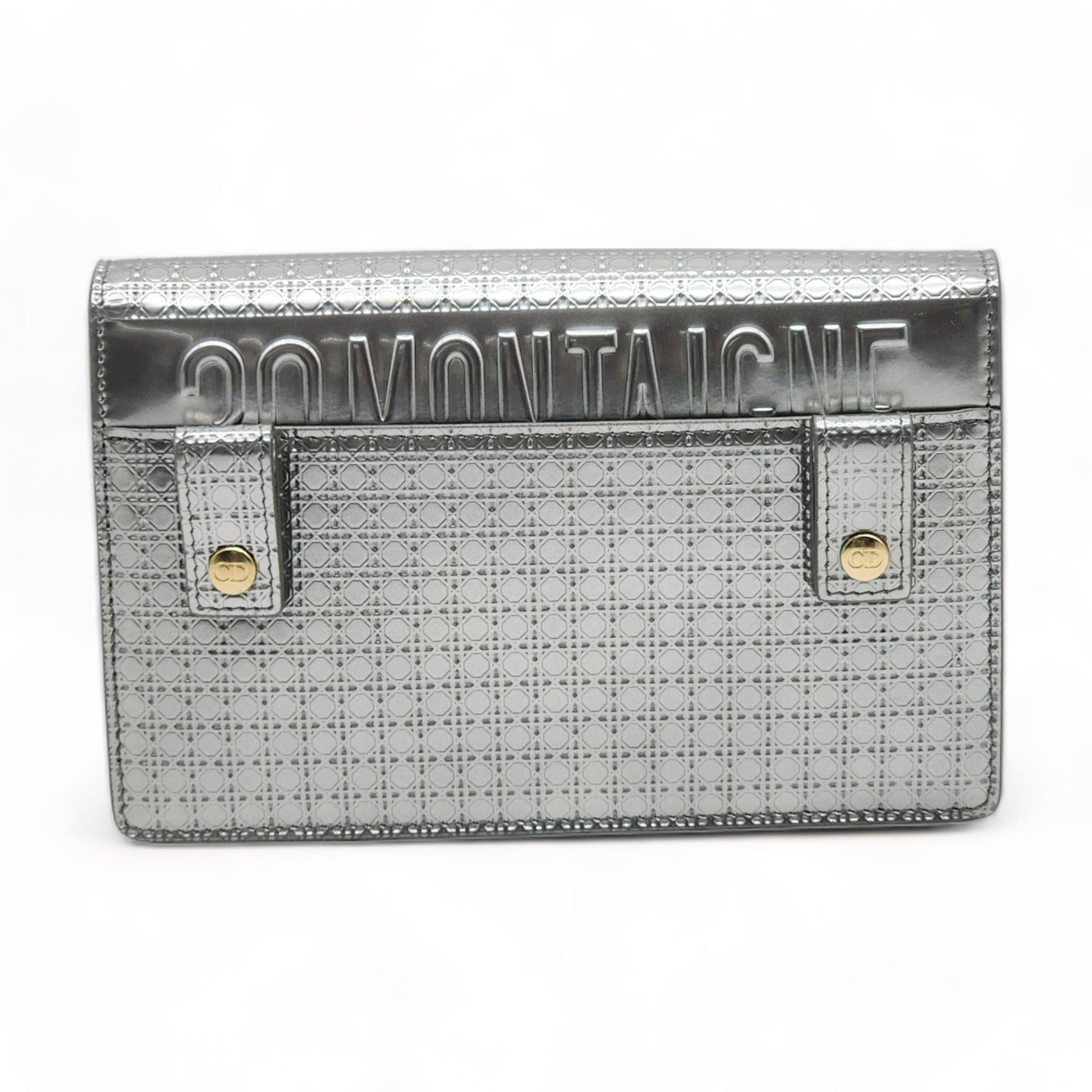 Features an adjustable belt strap, optional chain link strap, and polished gold hardware. The flap opens to a black suede interior with pockets and four card slots.

Additional information:
Material: Leather
Micro cannage monogrammed
Color: