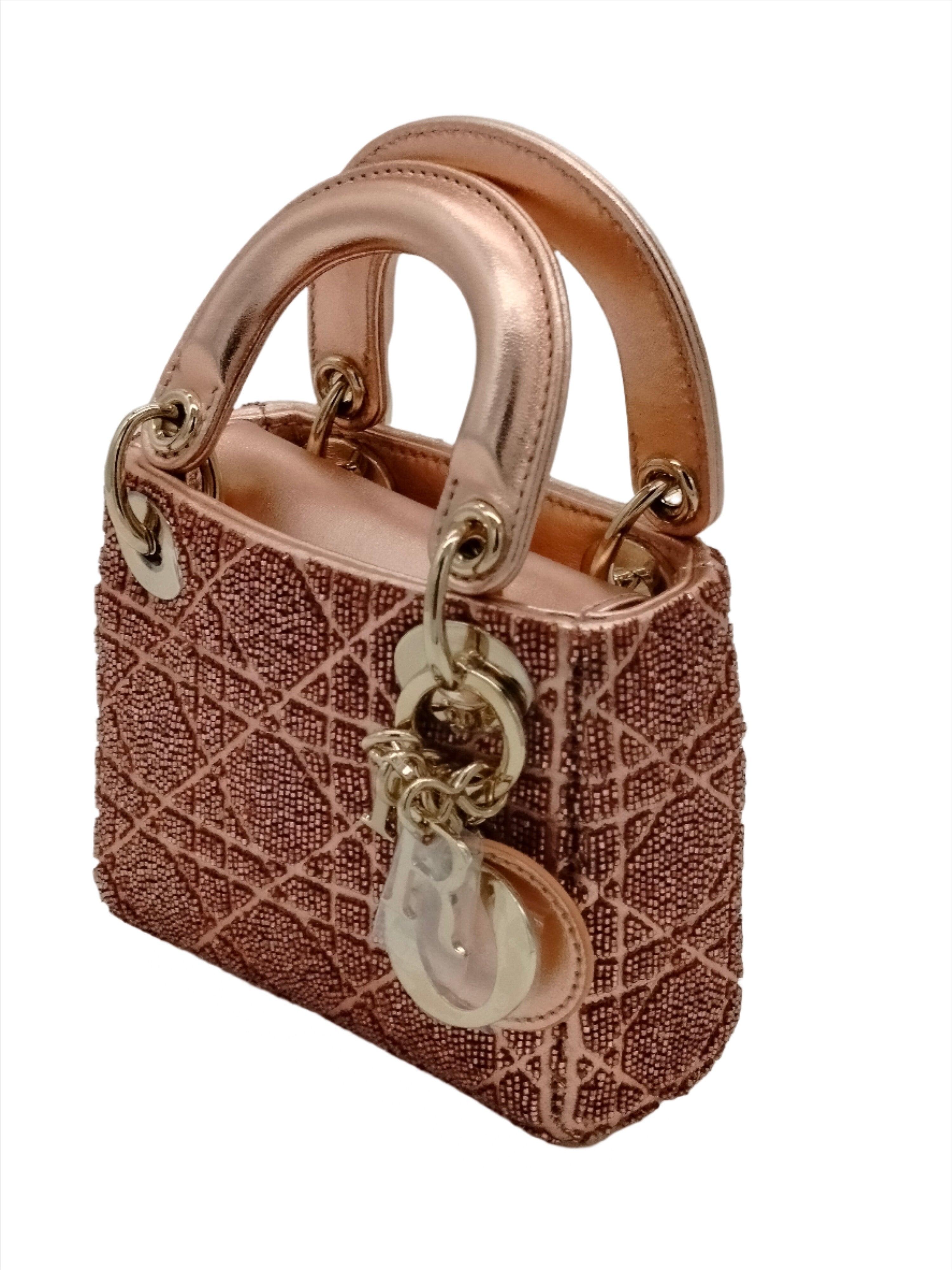 The Lady Dior miniature bag embodies the brand's vision of elegance and beauty. Crafted in pink sequins with signature Cannage stitching and its iconic silhouette adorned with a DIOR charm, the Lady Dior bag holds all the small essentials and can be