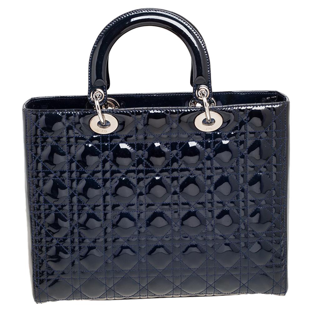 A timeless status and great design mark the Lady Dior tote. It is an iconic bag that people continue to invest in to this day. We have here this classic beauty crafted from midnight blue patent leather. The bag has a lined interior for your