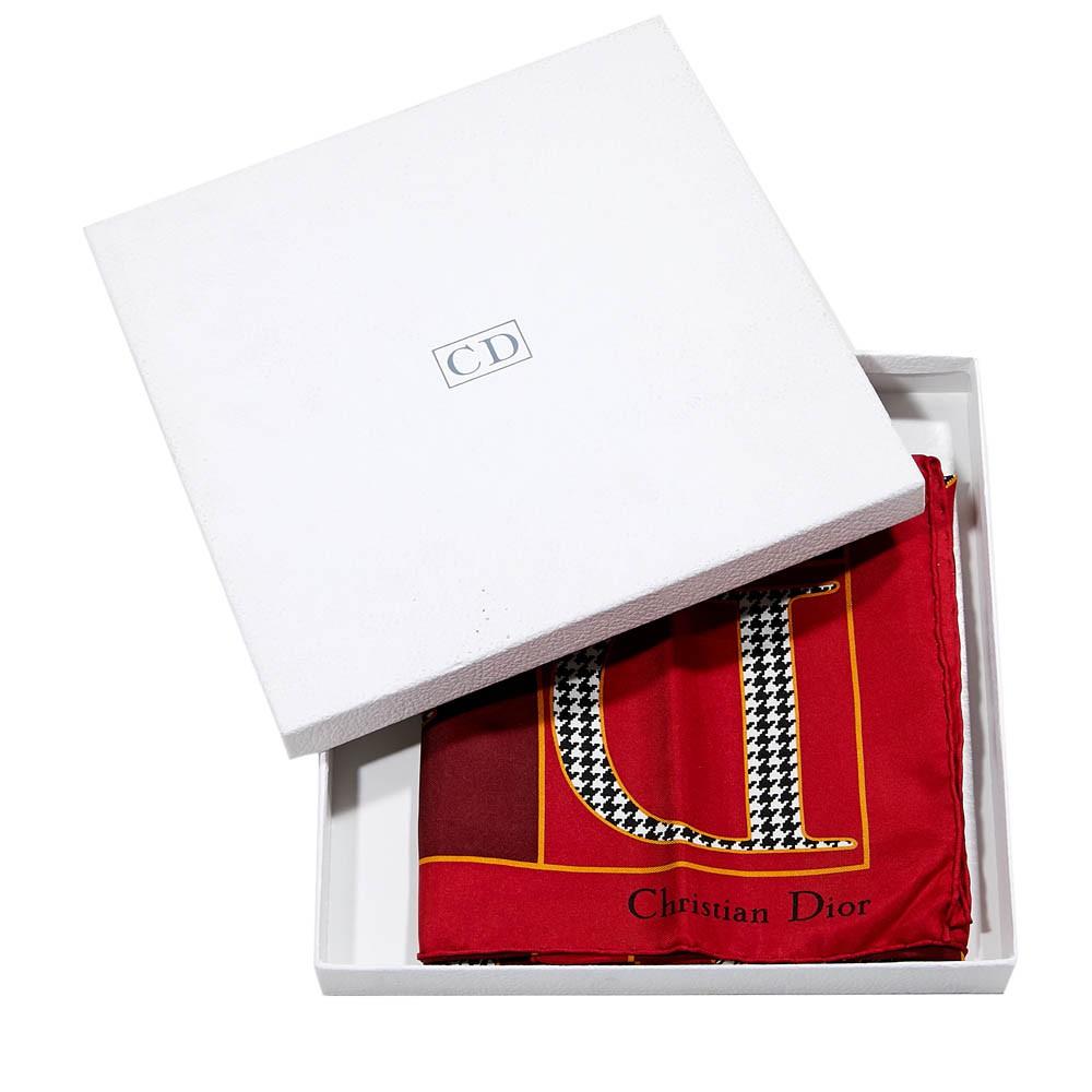 Never worn, with the box, this scarf is made of Silk, 100%, as written on the composition label. It shows interlocked letters that composed the Dior name.  Designed with red and black. Made in Italy. Can be worn as a headband or around the neck as a