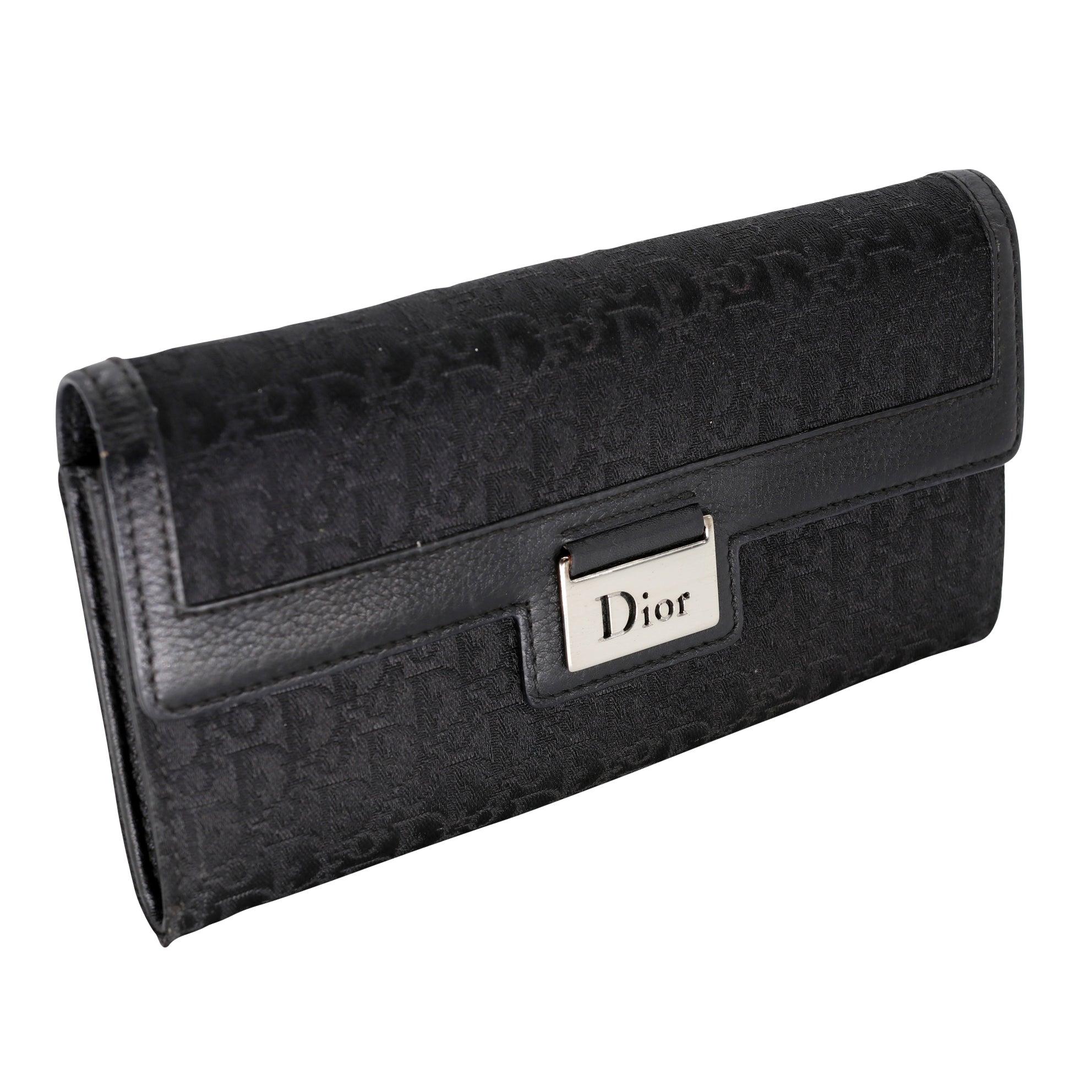 Here is another timeless piece by the famous DIOR house the signature monogram that made them famous on black Noir canvas. Wallet includes long wallet compact and practical alternative to the traditional wallet. It is crafted in Black Dior Oblique