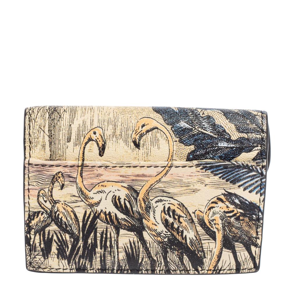 This Saddle card holder from the House of Dior will be your favorite! It is created using multicolored butterfly printed leather, with a D charm hanging down the front. It features a nylon-leather interior. Carry this card holder and flaunt your
