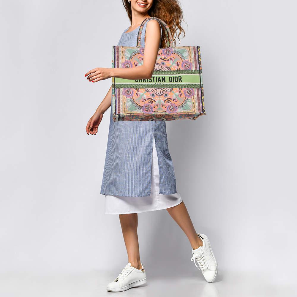 Designed by Maria Grazia Chiuri, the Dior Book Tote is a travel accessory for people with style. The bag here is crafted using canvas into a beautiful structure and covered in signature embroidery all over. Two handles, the 'Christian Dior'