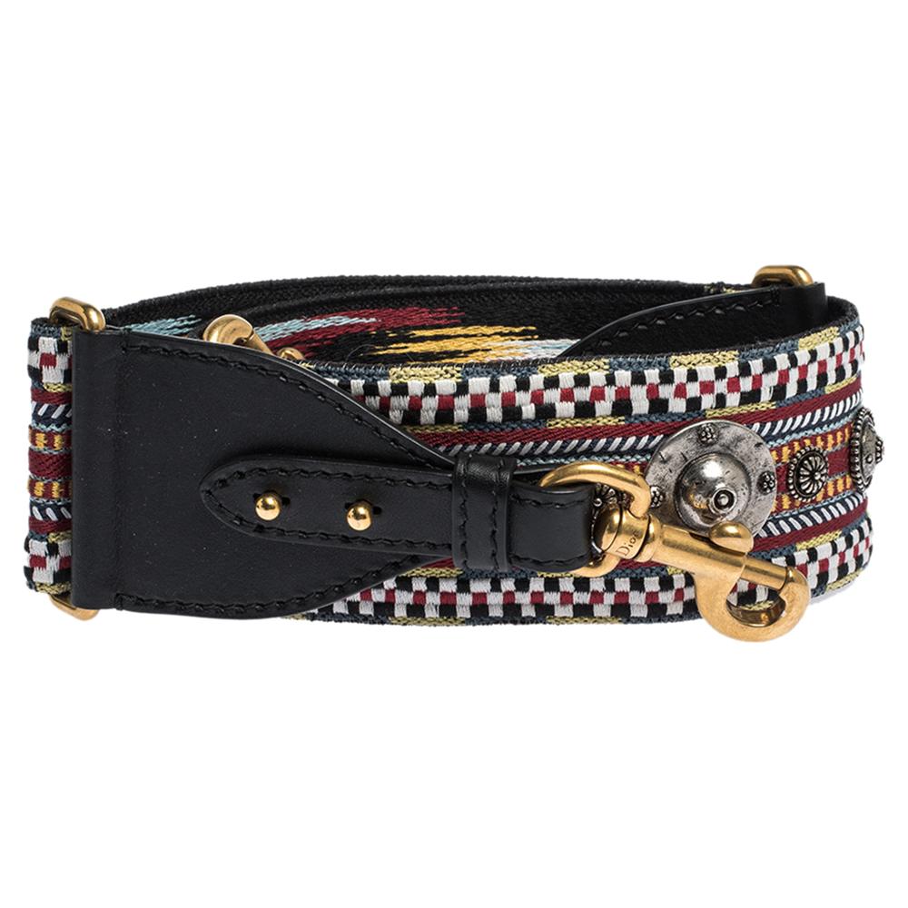 Words fall short to describe this exquisite shoulder strap from Dior! Crafted with love from canvas and leather, the strap flaunts a Bohemian-inspired design and detailing of studs. Complete with two clasps, it can easily change the look of any