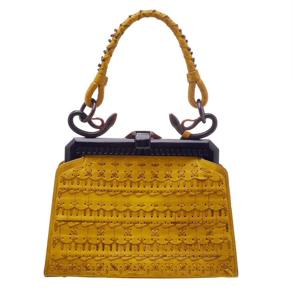 This exquisite Dior bag comes with a sophisticated exterior crafted from quality woven leather and accented with exquisite stitch detailing. It comes in lovely shades of yellow & brown and is designed with a framed top, a well-designed handle, and a