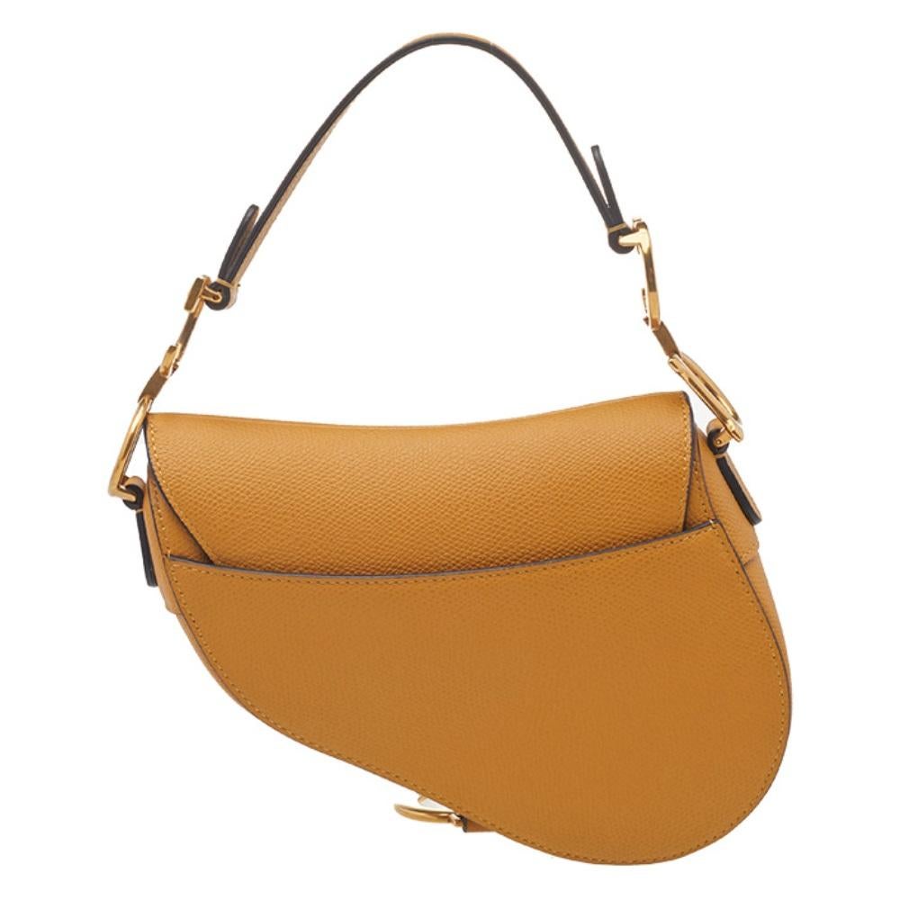 An example of timeless style and great design ideas, Dior's Saddle bag is sought after for all the right reasons. This Saddle bag for women is crafted using mustard leather in the iconic shape and it has gold-tone CD letters to hold the single