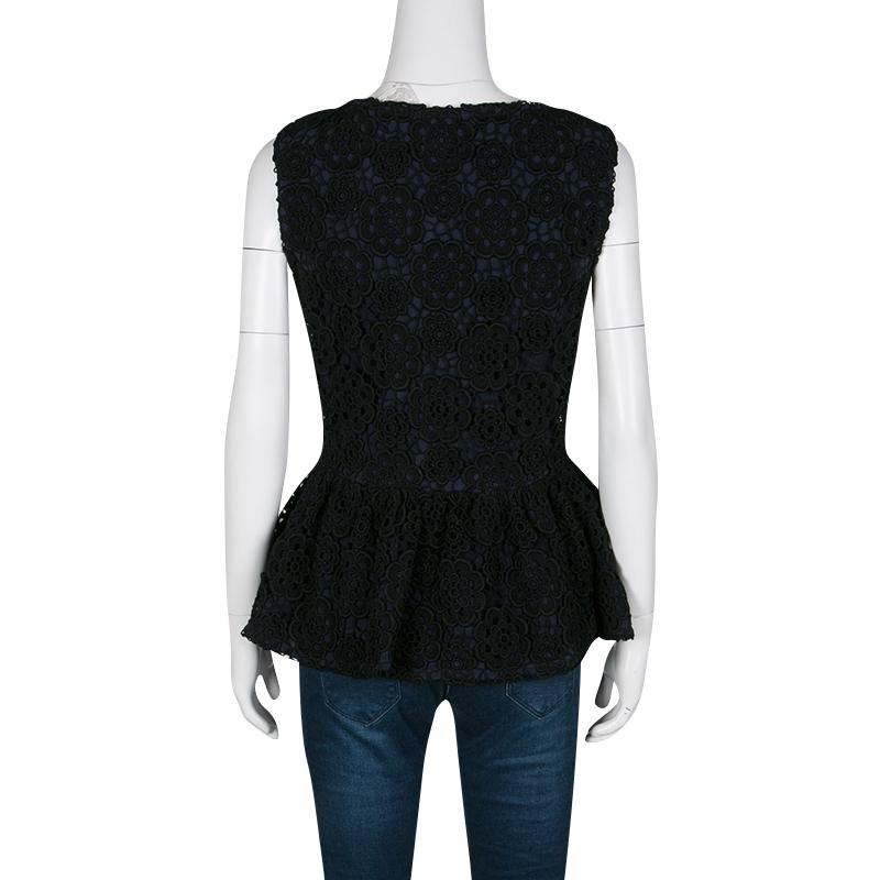 Dior's top, made from cotton, is a lovely piece to don an understated yet chic ensemble for your evening look. Beautifully detailed with floral lace overlay, this sleeveless top is pleated below the bust creating a loose peplum shape. It works best