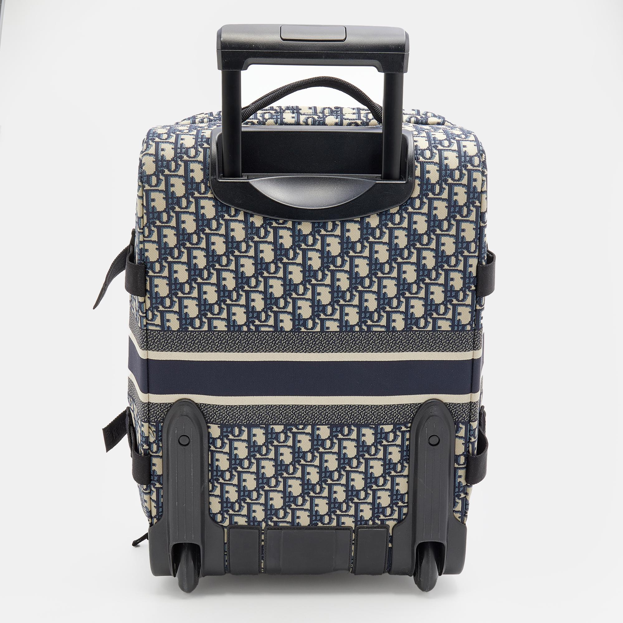 
Casual elegance meets brand codes to form the DiorTravel suitcase. It is crafted using waterproof Oblique jacquard and emblazoned with the 'CHRISTIAN DIOR PARIS' sign on the exterior. It is supported by two wheels and a telescopic cane.

Includes: