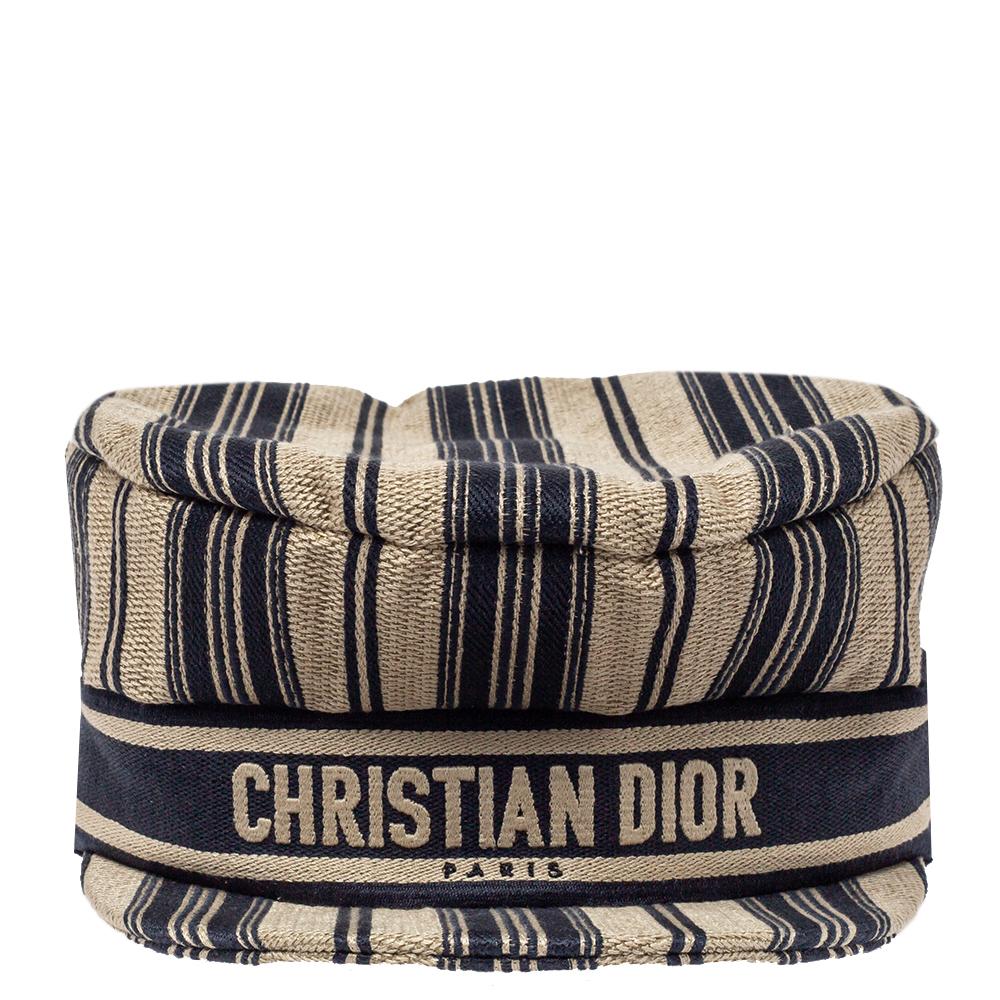 Dior's Bayadère Newsboy hat is a fine update of a classic. Made from cotton in stripes of beige and navy blue, the hat is detailed with a trim embroidered with 'CHRISTIAN DIOR'.

Includes: Original Box