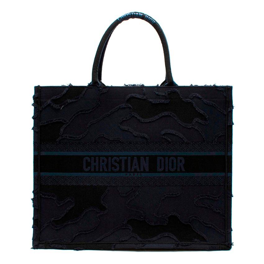 Dior Navy Blue Camouflage Embroidered Book Tote 

- Staple Dior Book Tote Style 
- All-over Navy canvas 
- 'Christian Dior' signature on front and handles
- Can be carried by hand or worn over the shoulder
- Original dust bag, box and carrier bag