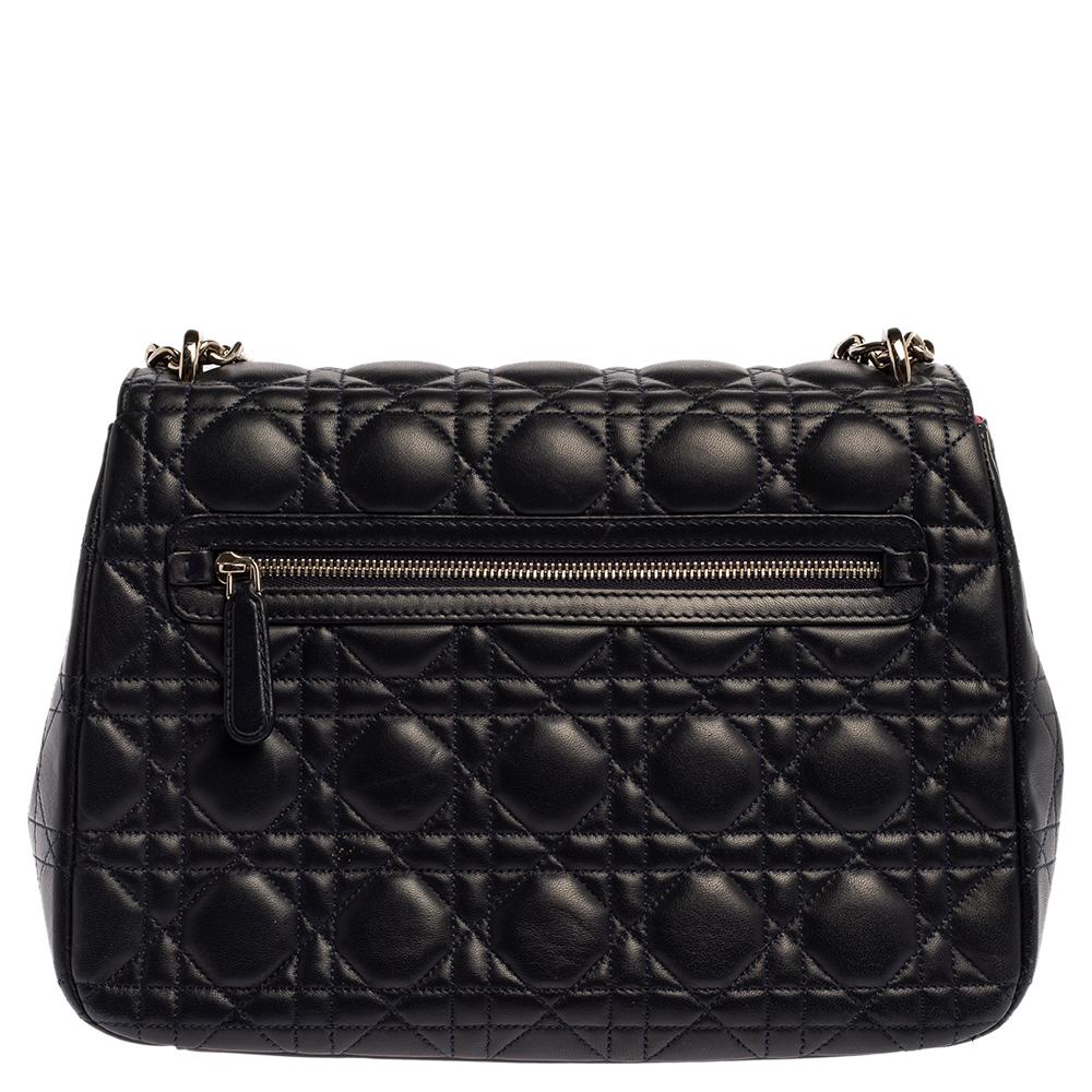 Flap bags like this Miss Dior will never go out of style. Crafted from leather, this Dior flap bag features a navy blue Cannage exterior and a chain strap. The front flap has a Dior lock that opens to a leather-lined interior with enough space to