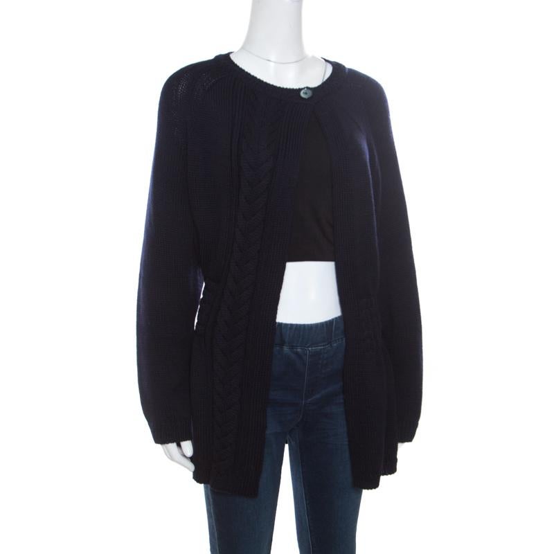 Nail the art of layering by adding this cardigan from Dior into your wardrobe. Knitted in a chunky cable style, the cardigan has a pair-it-with-all navy blue hue that suits the winter mood just right. It is spun from luscious wool to keep you warm