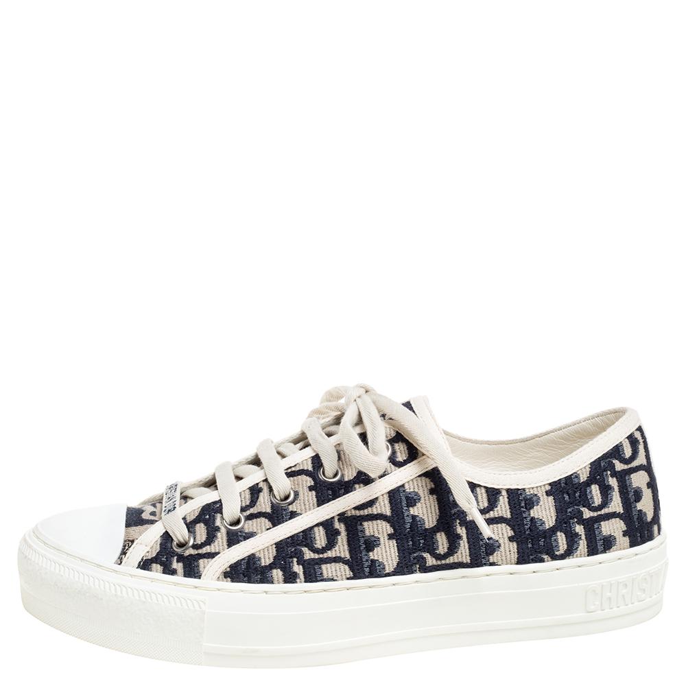 Let your latest shoe addition be this pair of much-coveted Walk'n'Dior low-top sneakers from Dior. They've been crafted from navy blue Oblique-embroidered cotton and styled amazingly with lace-ups, the brand logo on the vamps, comfortable leather