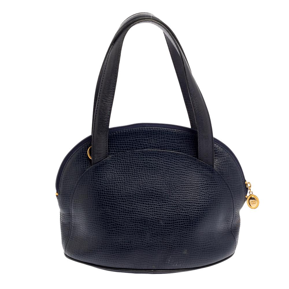 From the fashion house of Dior comes this satchel that is absolutely flaunt-worthy. The navy blue bag has been crafted from grained leather and styled with dual top handles. It opens to reveal a spacious leather interior that can graciously