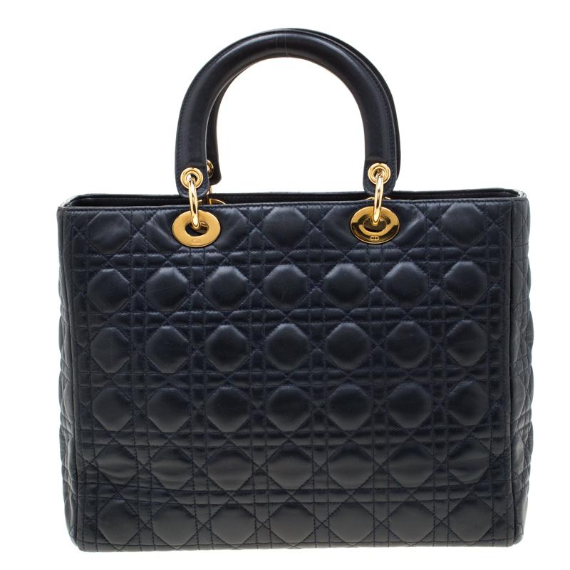 The Lady Dior tote is a Dior creation that has gained recognition worldwide and is today a coveted bag that every fashionista craves to possess. This navy blue tote has been crafted from leather and it carries the signature Cannage quilt. It is