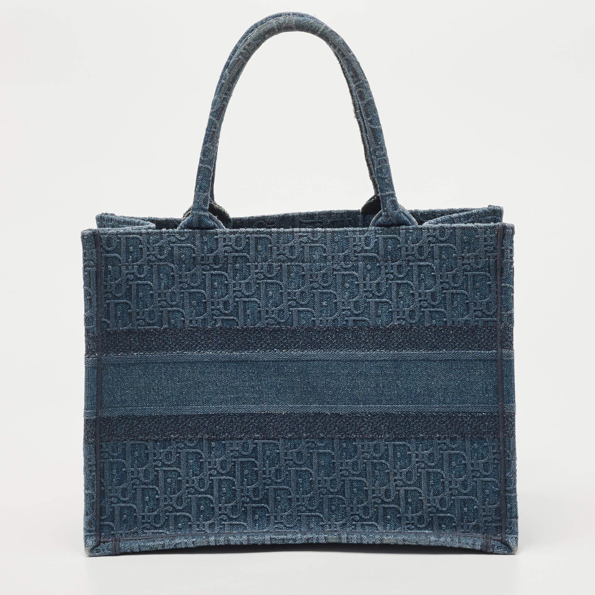 Designed by Maria Grazia Chiuri, the Dior Book Tote is a travel accessory for people with style. The bag here is crafted using denim into a beautiful structure and covered in Oblique embroidery. Two handles, the 'Christian Dior' signature, and a