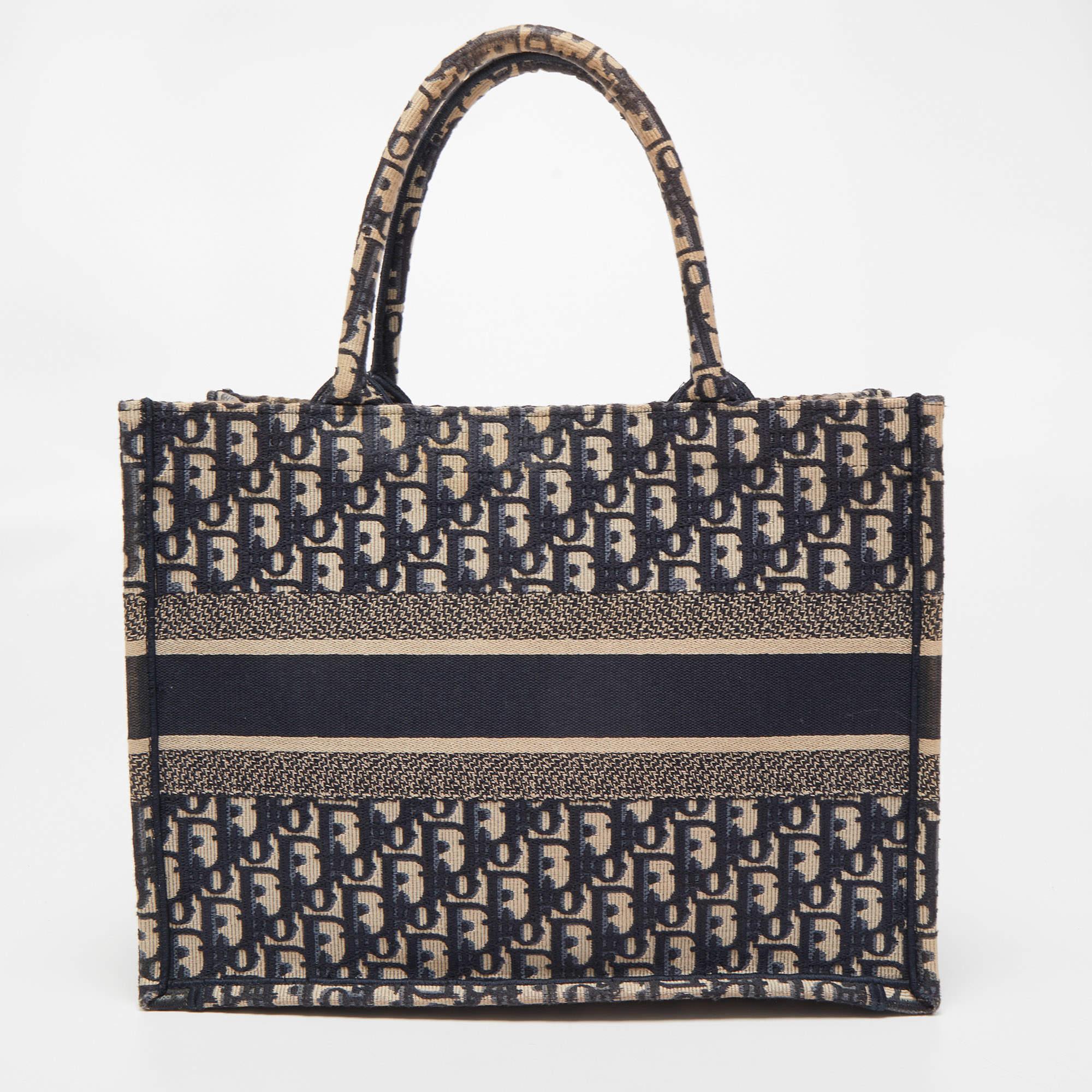 
Designed by Maria Grazia Chiuri, the Dior Book Tote is a travel accessory for people with style. The bag here is crafted using canvas into a beautiful structure and is covered in Oblique embroidery. Two handles, the 'Christian Dior' signature, and