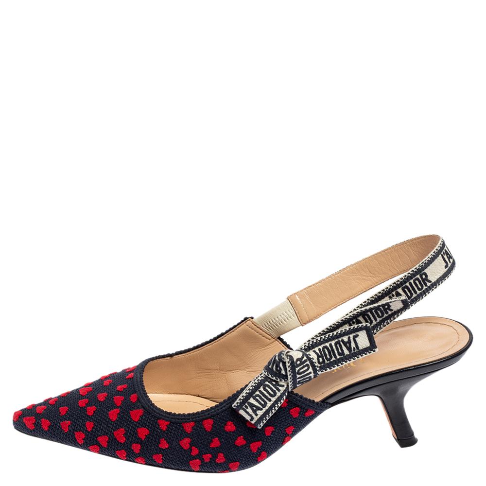 You'll definitely receive compliments wherever you go when you step out in these lovely pumps from Dior. The navy blue pumps are crafted from red heart-embossed canvas and feature pointed toes. They flaunt 'J'adior' ribbons and come equipped with