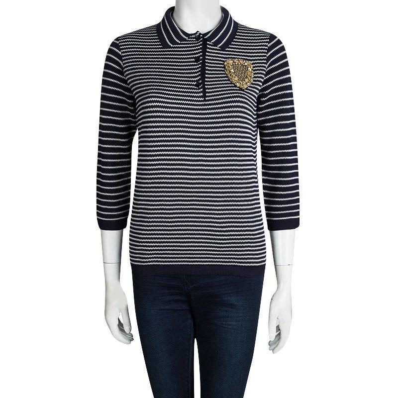 For all the fashionistas who like to add a bit of bling even to the most basic looks, this Dior top is an apt choice. Impressively tailored, in a navy blue striped knit, this top features long sleeves and a classic buttoned collar neckline. A golden