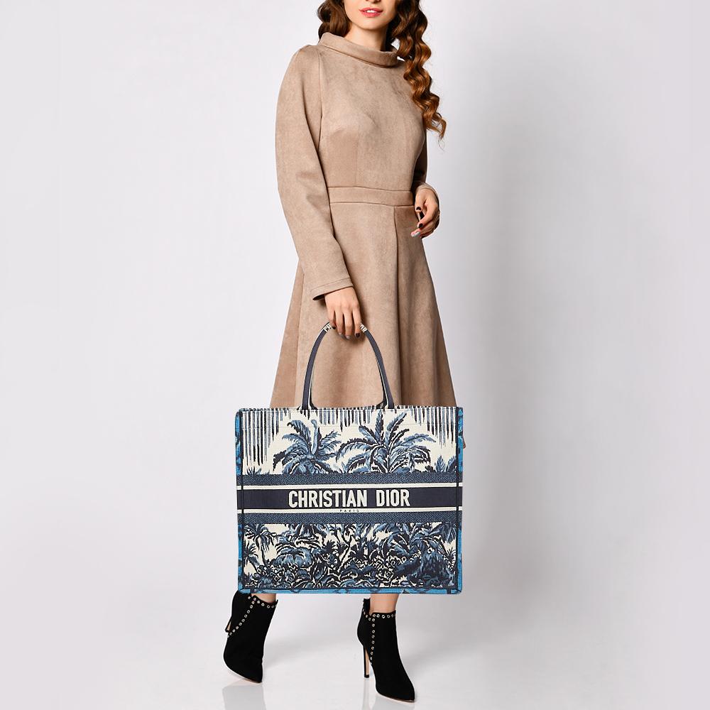 Designed by Maria Grazia Chiuri, the Dior Book Tote is a travel accessory for people with style. The bag here is crafted using canvas into a beautiful structure and covered in striking embroidery all over. Two handles, the 'Christian Dior'