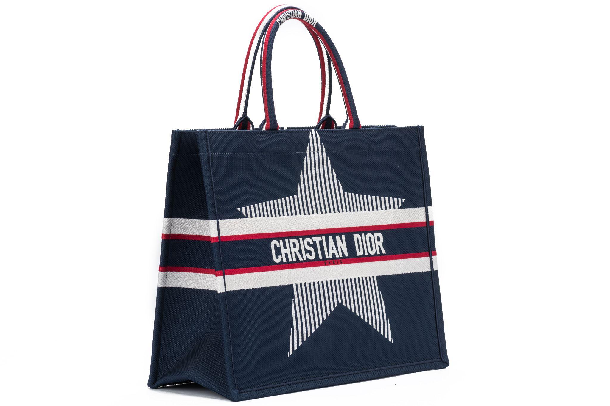 DIOR brand new large Alps book tote in navy blue with a white star in the center written Christian Dior over it. The piece comes with the original dustcover. The handles are 6.25 inches.