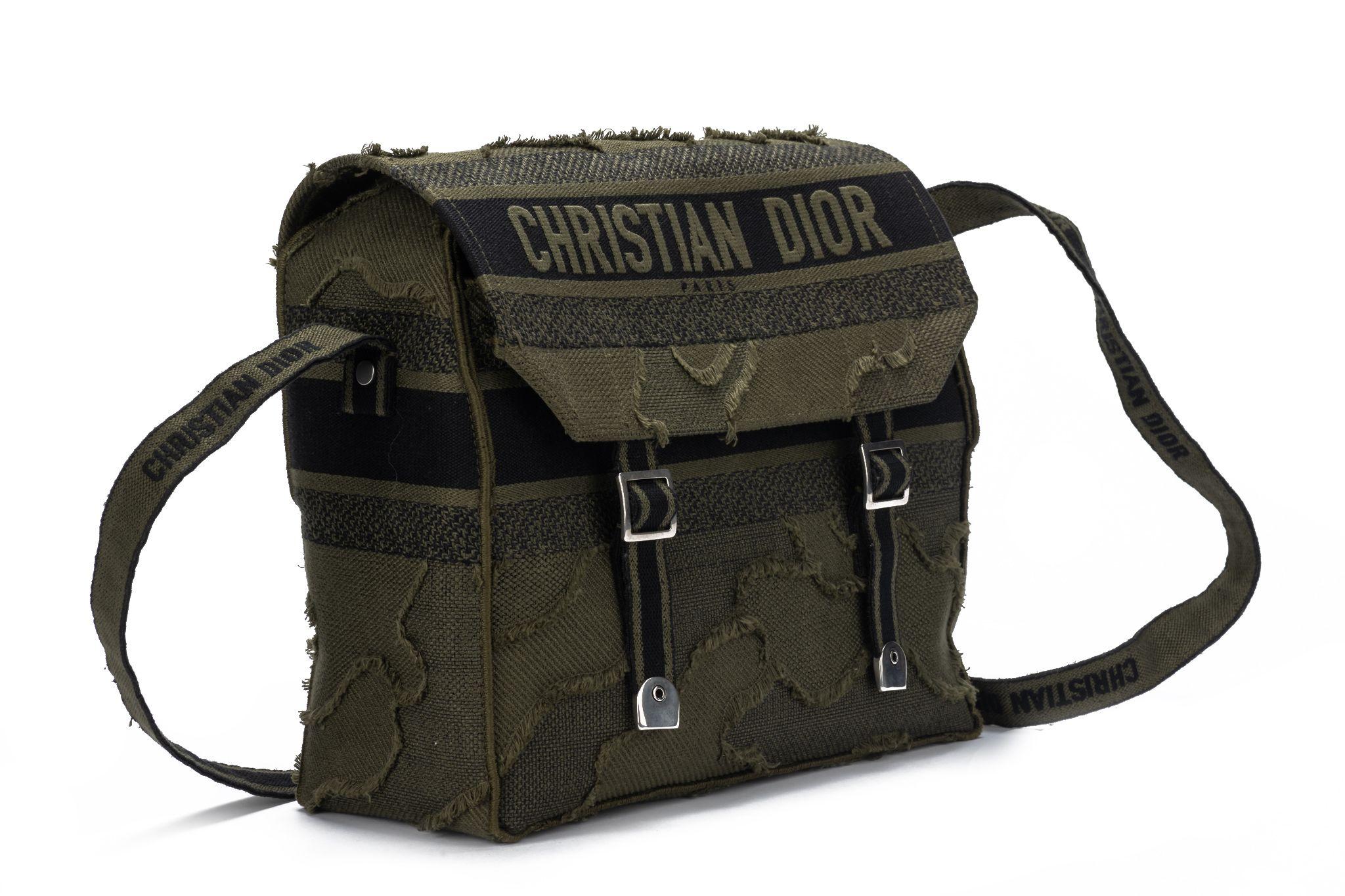 CHRISTIAN DIOR brand new Canvas Embroidered Camouflage Dior Messenger Bag in Green. This flap bag is finely crafted of dark green and black canvas with a unique design and adorned with 