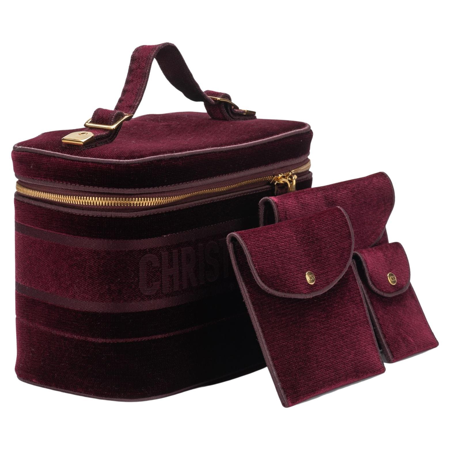 Dior brand new large travel bag in deep burgundy velvet with zipper and golden details. Can also be used for cosmetic items or your jewelry! The different pockets measure 6.75x5.25”; 5x5” and 2.75x3.5. 
Comes with original dustcover and tag.