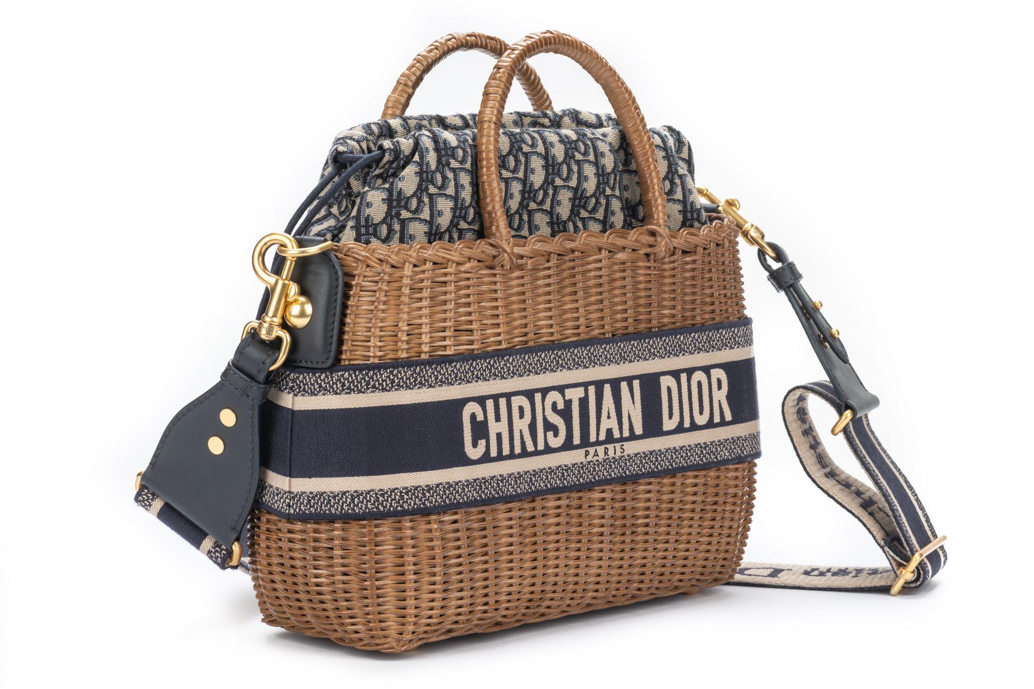 DIOR new Wicker Oblique Basket Bag in Blue. This bag is crafted of Dior monogram canvas and blue leather trim. The bag features a gold chain strap (20'), handles on top (4.5') and a leather cinch cord closure. The interior opens to a Dior monogram
