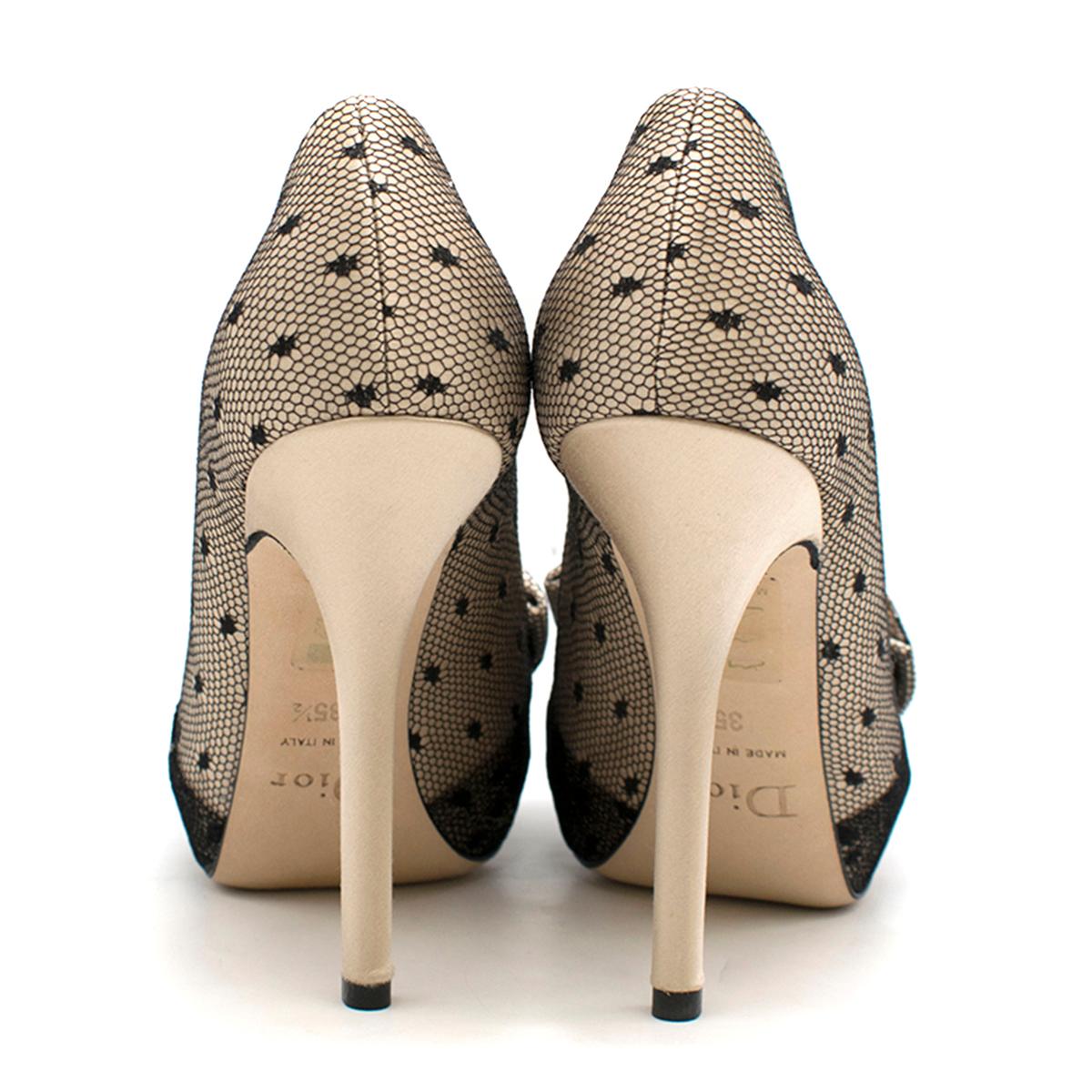 Dior Nude Silk Lace Embellished Pumps 

- Nude silk pumps embellished with black lace
- Open toe
- Hidden platform
- Decorative bow
- Stiletto hill
- Nude leather sole and insole

This item comes with the original dust bag

Please note, these items