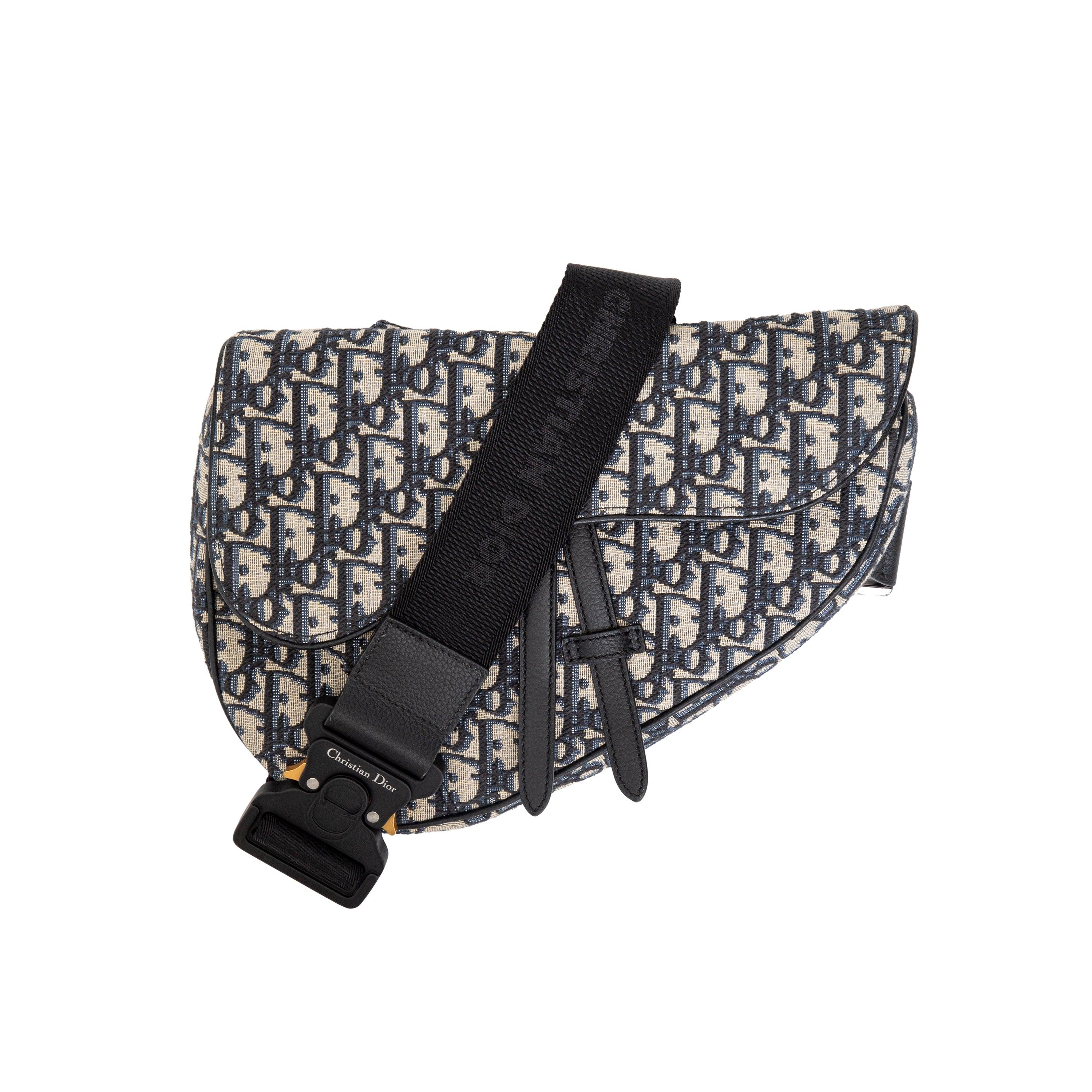 Introducing the Dior Oblique Jacquard Saddle Bag. This iconic bag boasts a magnetic flap with zipper closure, adjustable shoulder strap, and signature Dior Oblique jacquard pattern. Stay stylish and organized with the Dior signature embossed