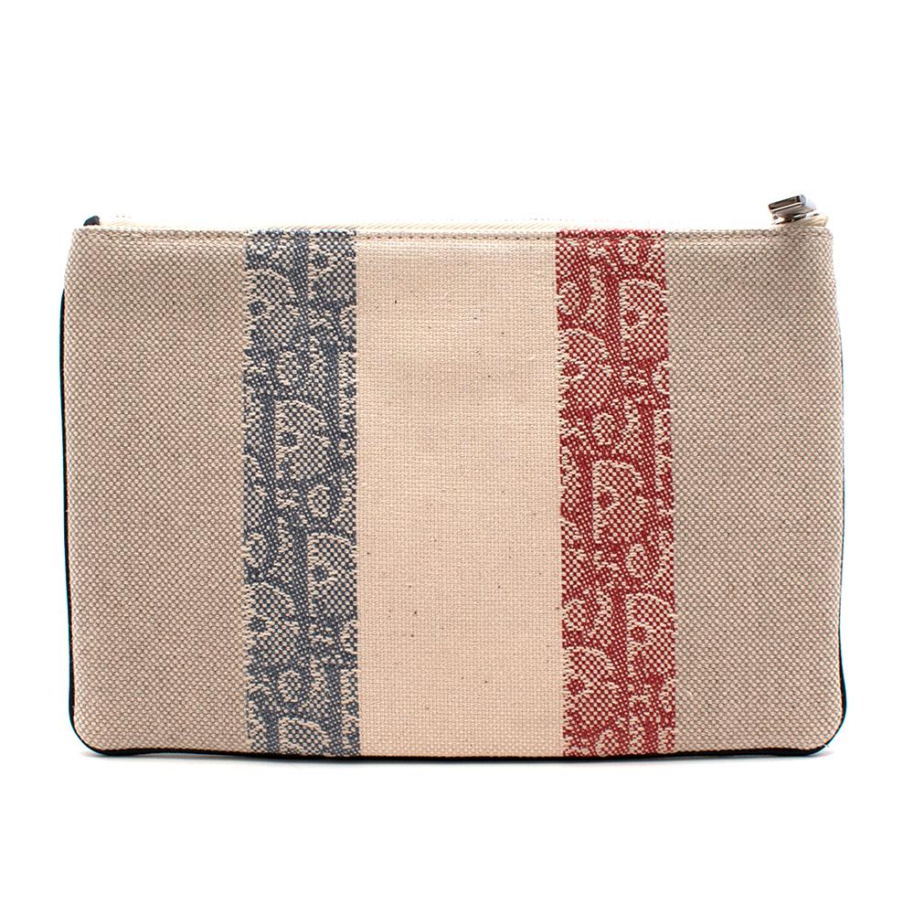 Dior Monogram Cream Fabric Clutch

- Monogram Red and Blue Stripes 
- Top Zip Fastening 
- Brand Small Back Dior Hardware 
- Fabric Trim 
- Fully Lined 

Material:
- 100% Canvas
- 100% Nylon

Height: 16cm
Length: 23cm
Width: 2cm
Depth: 15.5cm