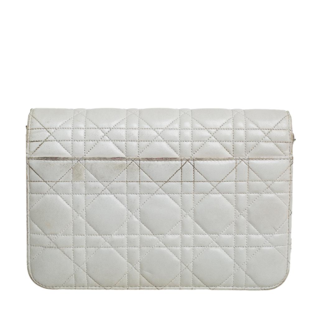 Flap bags like this Miss Dior will never go out of style. Crafted from leather, this Dior bag features an off-white Cannage quilted exterior and a chain-link and leather shoulder strap. The front flap has a silver-tone lock that opens to a leather
