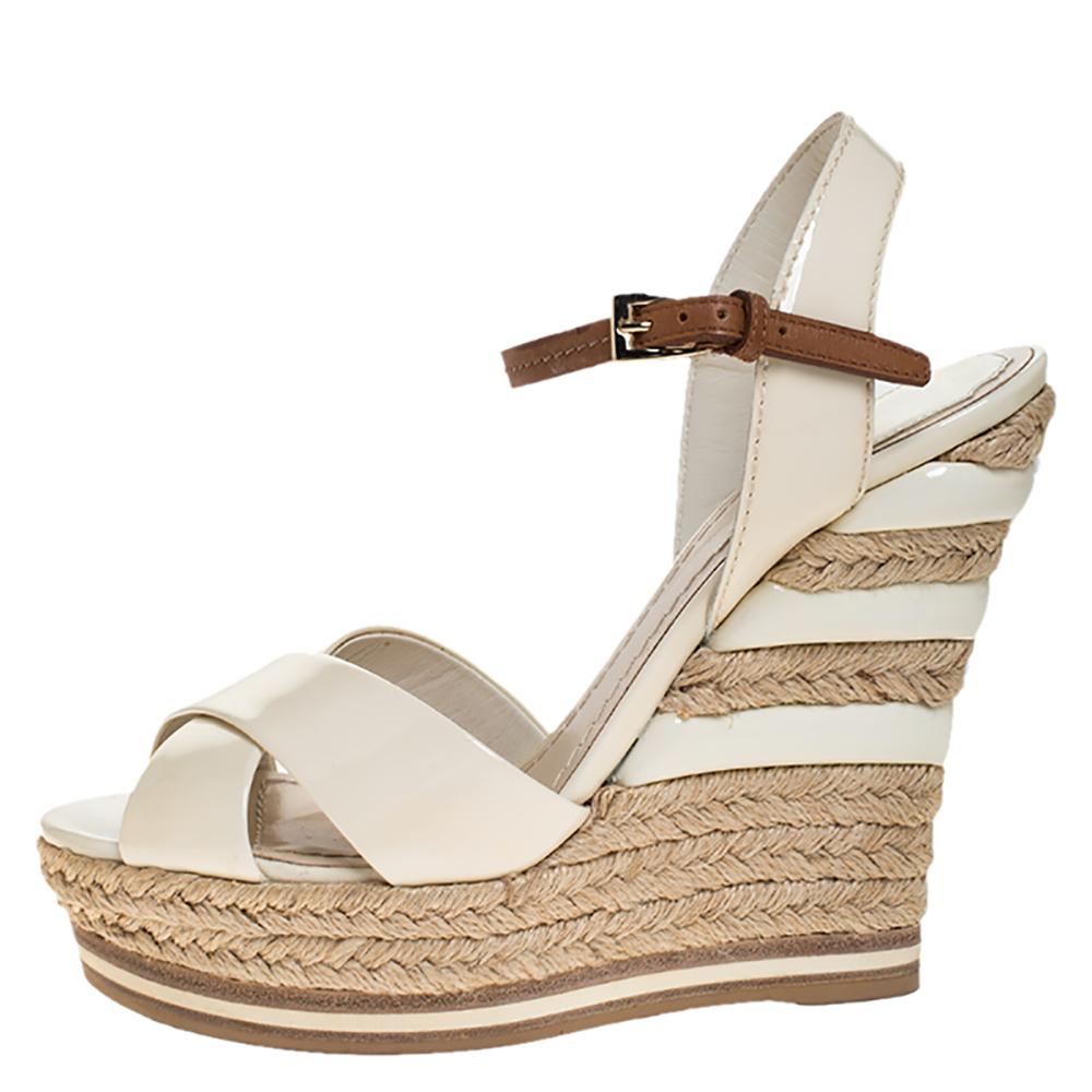 Every woman knows that wedges, no matter how high, are pretty easy to walk in. These Dior ones are the same, but with more fun and style. They've been designed with open toes and ankle fastening. Elevated on 12.5 cm espadrille wedges, this pair will