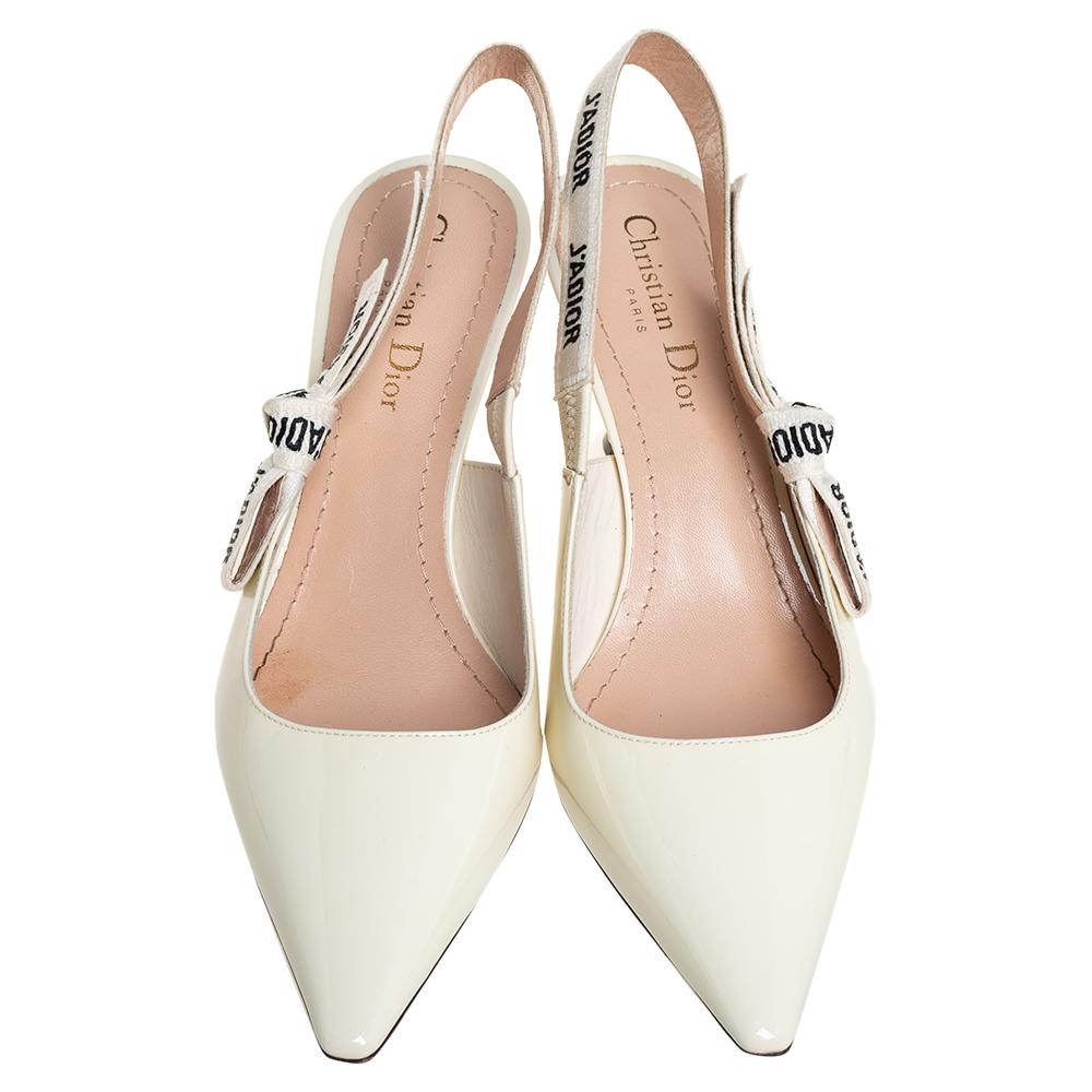 A coveted Dior silhouette that's loved by women around the world. These off-white J'adior sandals are crafted from patent leather and styled with pointed toes and J'adior ribbon slingbacks. They are complete with comfortable leather insoles and 7 cm