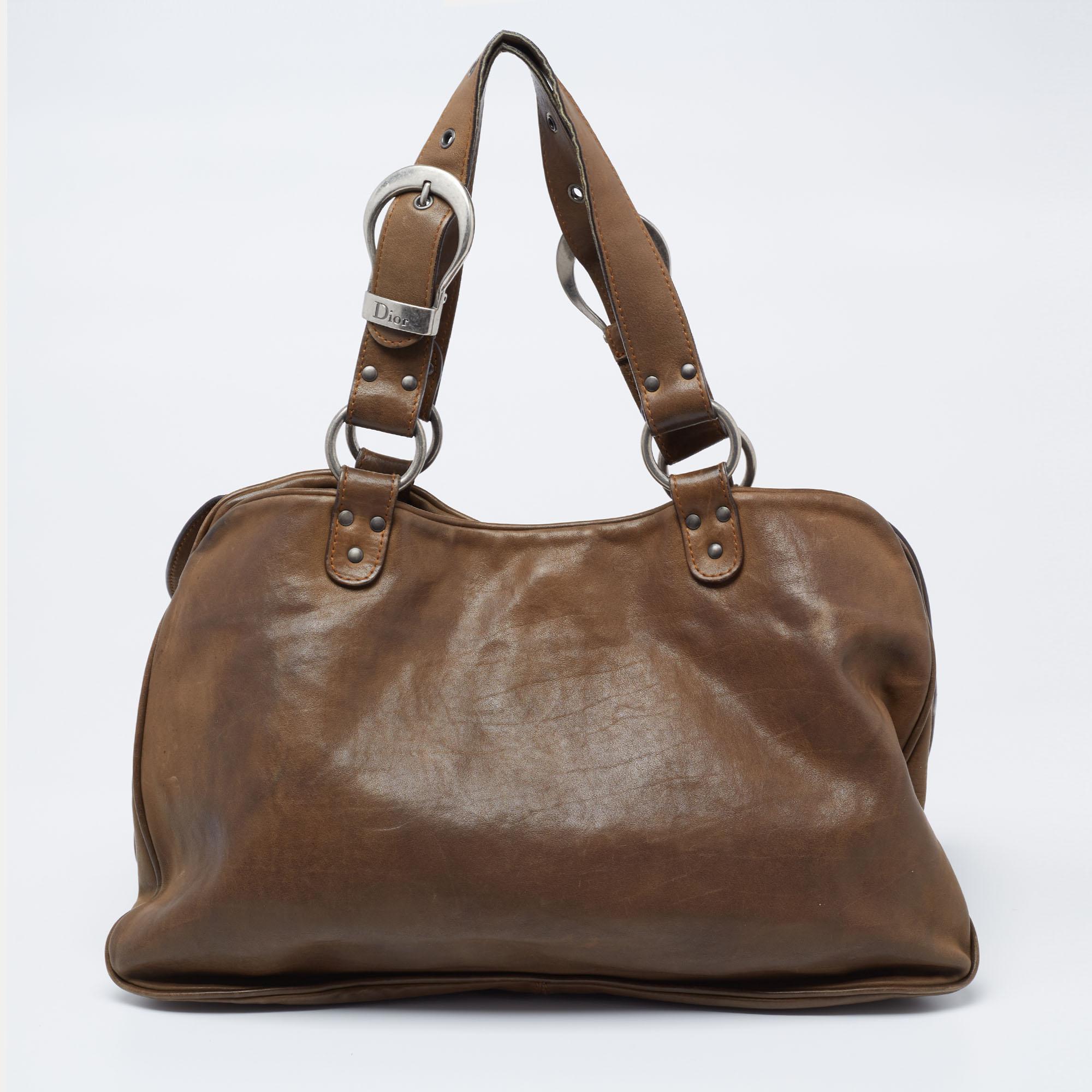 From the house of Dior, this Double Saddle bag is an excellent blend of elegance and style. The bag features a chunky buckle with an attached key on the front flap and a nylon-lined interior for your essentials.

Includes: Original Dustbag

