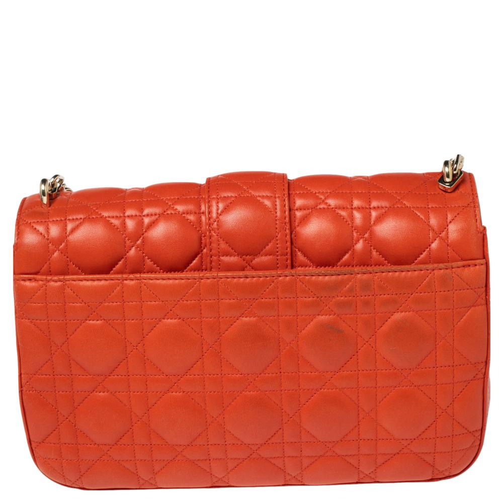 Flap bags like this Miss Dior will never go out of style. Crafted from leather, this Dior flap bag features an Orange Cannage exterior and a chain strap. The front flap has a Dior lock that opens to a leather-lined interior with enough space to keep