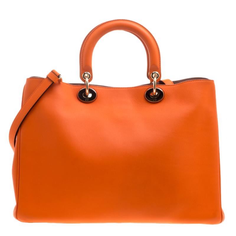 The Diorissimo bag from Dior is a piece that has never gone out of style. The leather bag comes in an enticing orange shade with silver-tone hardware and Dior letter charms. It features a pouch, double top handles, a shoulder strap and protective