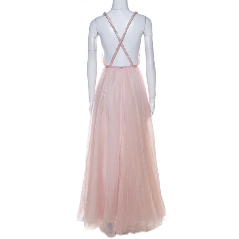A perfect dress to get your ready for parties and special events, this Dior cocktail dress is sure to steal your heart. Constructed in luscious pink silk, this dress features interesting twisted straps on the shoulders with a backless design to add