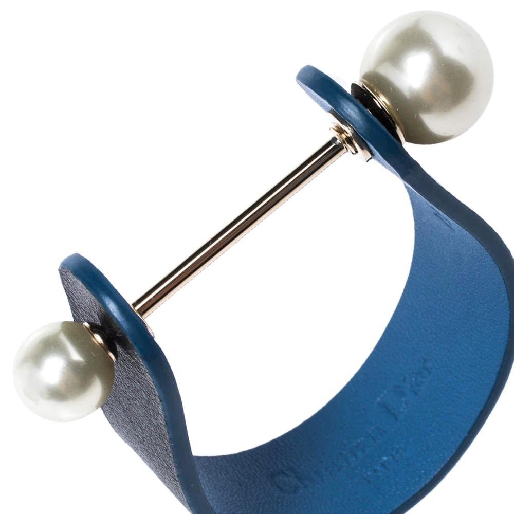 A unique and artsy bracelet to wear this weekend. Dior’s gold-tone cuff bracelet is designed with faux pearl closure and blue-hued leather makes this desirable. Wear it to work and mark your presence.

Includes: Original Dustbag, Original Box
