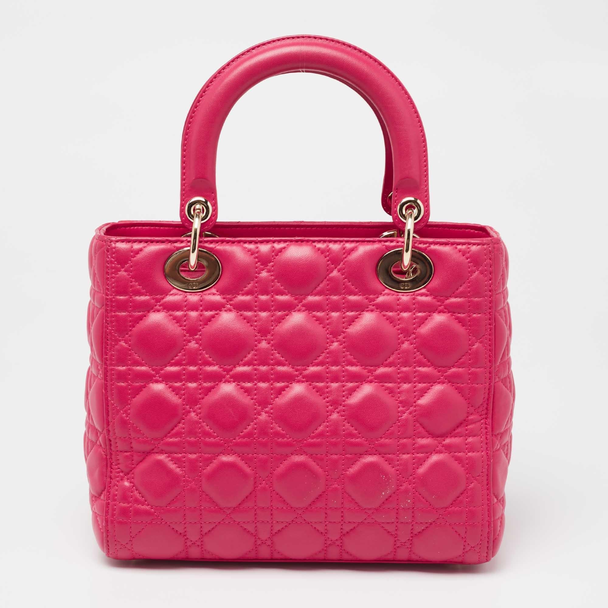 The Lady Dior tote is a Dior creation that has gained wide recognition and is a coveted bag that every fashionista craves to possess. This pink tote has been crafted from leather and carries the signature Cannage quilt. It is equipped with a fabric