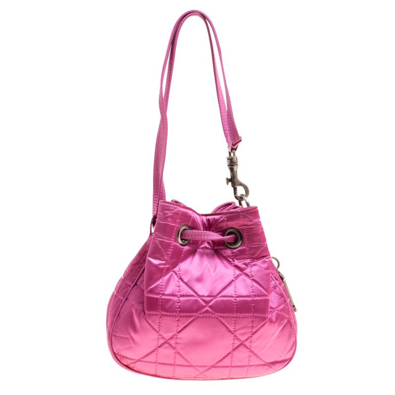 This stunning Dior design has a nylon exterior covered in their Cannage pattern. The bag has a bucket shape with a drawstring closure that secures the nylon interior and acts as the shoulder strap as well.

Includes: Packaging
