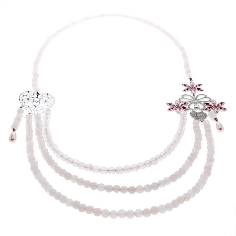 Complete a classy look with this Dior necklace. Giving the classic pearl necklace a twist, this beauty is crafted multi-strands of rose quartz. It has been given a regal look with a silver-tone heart motif with cutouts on one side and beautiful