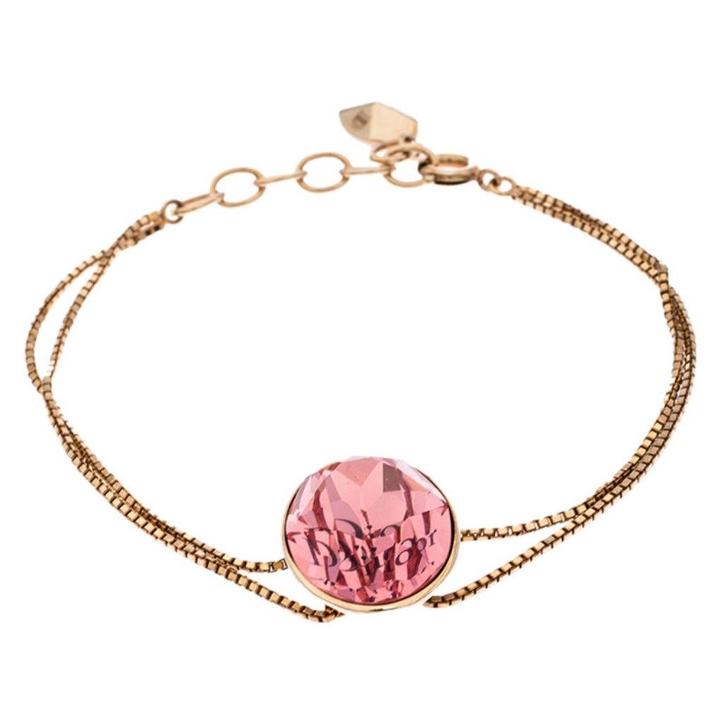 Sweet and feminine, this bracelet by Dior is a keeper. Made from gold-tone metal, the design is highlighted by a pink crystal detailed with 'Dior'. The adjustable twin chains are equipped with a spring-ring fastening.

Includes: The Luxury Closet
