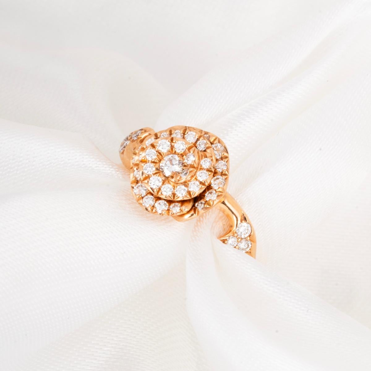 An18k pink gold diamond ring from the Couture collection by Dior. The ring features a blooming rose bud, pave set with round brilliant cut diamonds, approximate total weight of 0.30ct. The motif measures 10mm in width, the ring has a gross weight of