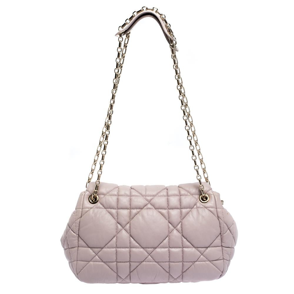 Add a sturdy pink bag to your wardrobe with this Dior leather shoulder bag. It is chic, reliable and will go with any of your outfits. It features Dior's signature cannage pattern on the exterior, double chain handles with leather shoulder rest and