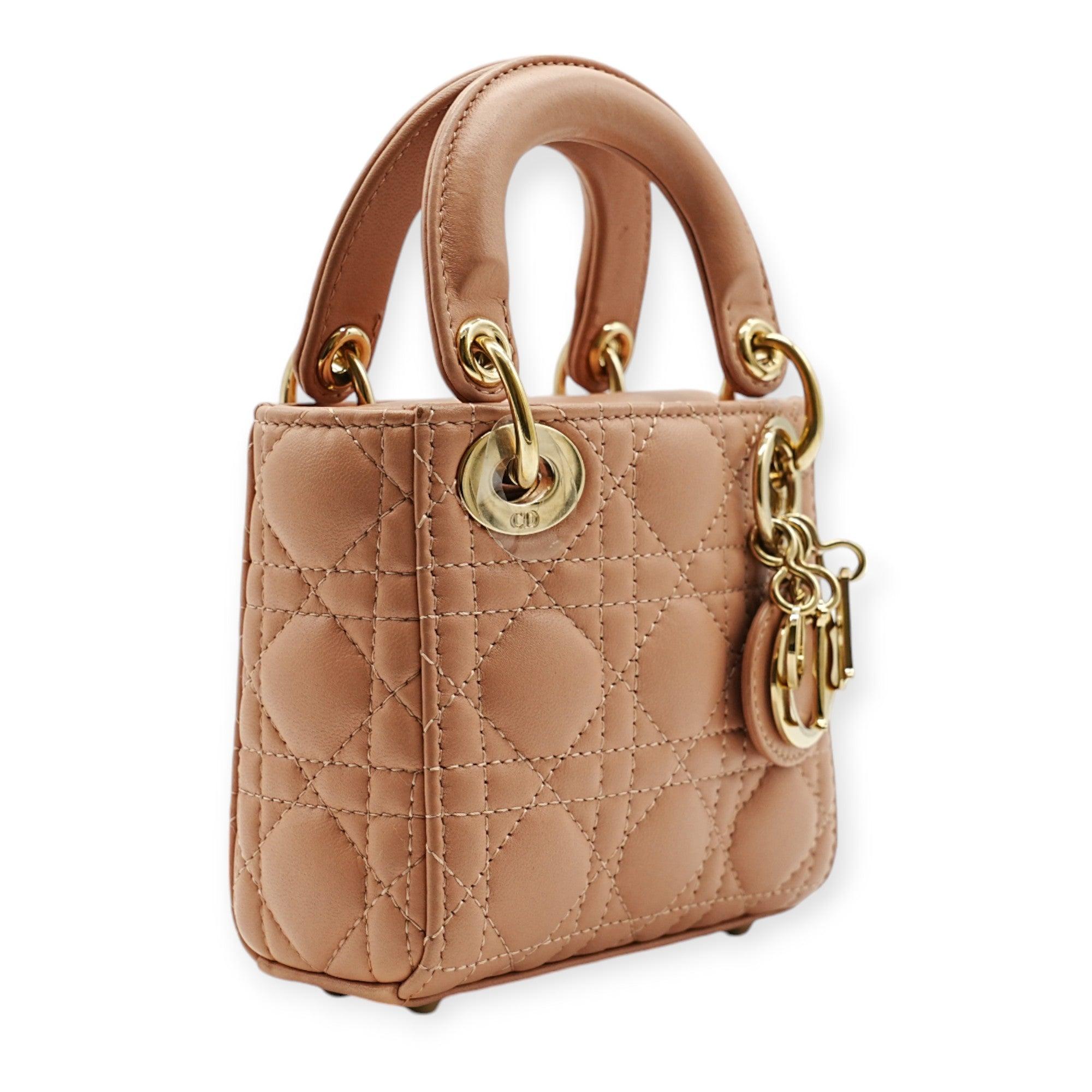 The Dior Pink Lady Dior Micro Three Squared Shoulder Bag is a compact, structured accessory featuring the iconic cannage pattern. Crafted in soft pink leather, it comes with a delicate chain strap for crossbody wear. A chic and versatile piece for a