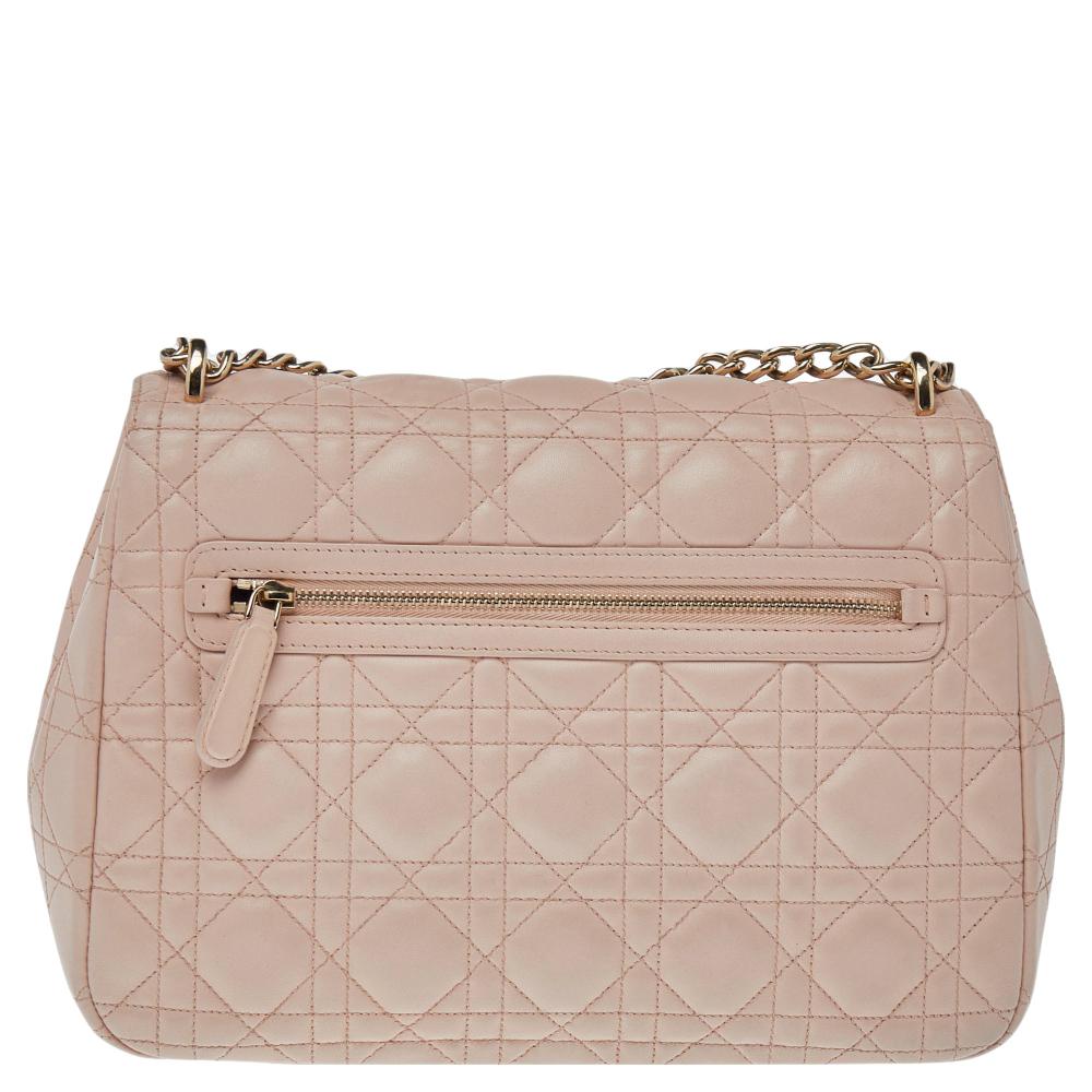 Flap bags like this Miss Dior will never go out of style. Crafted from leather, this Dior flap bag features a pink Cannage exterior and a chain strap. The front flap has a Dior lock that opens to a leather-lined interior with enough space to keep