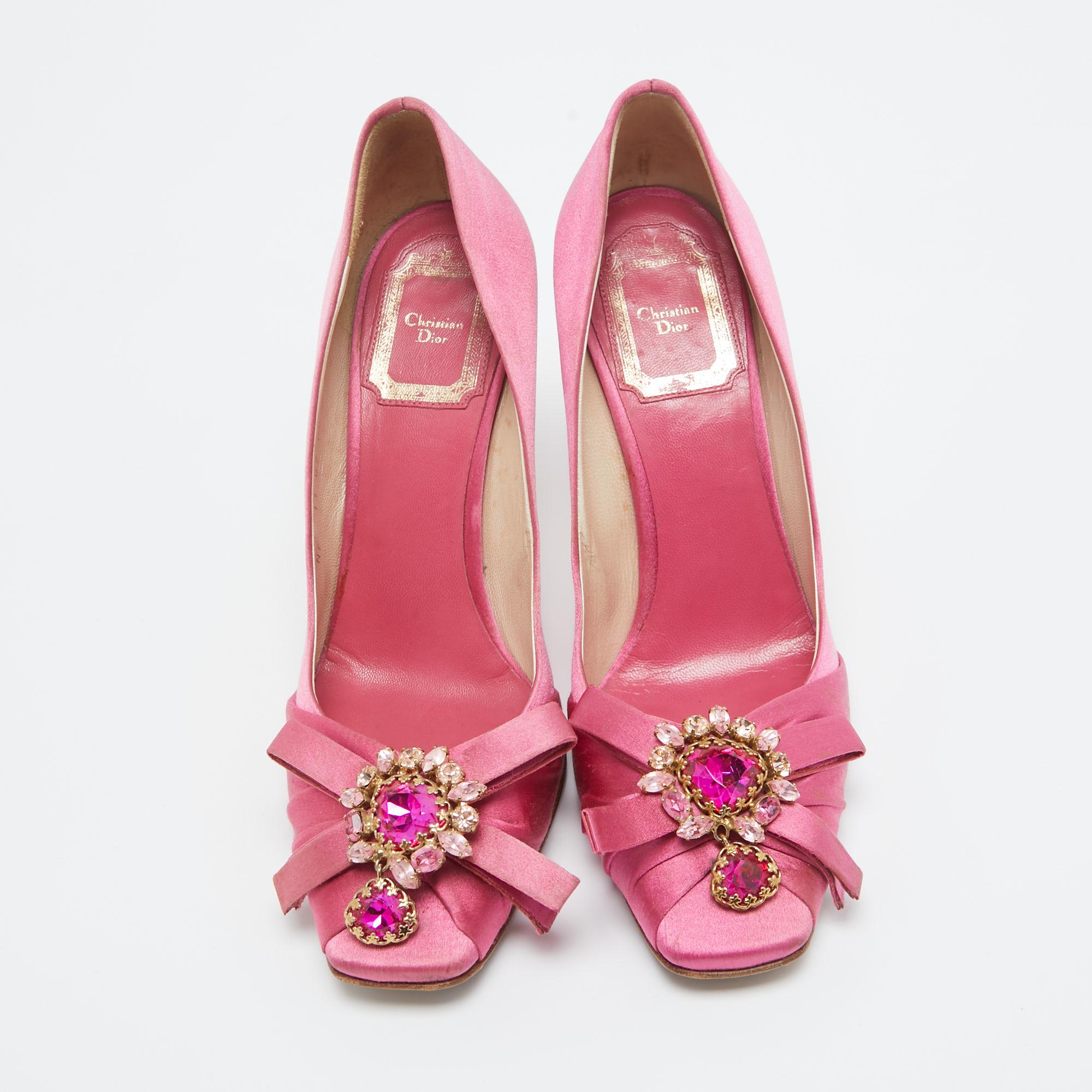 The elegant pumps are covered in pink satin and lined with leather. Embellished uppers, low platforms, and high heels complete the stunning design.

Includes
Original Box