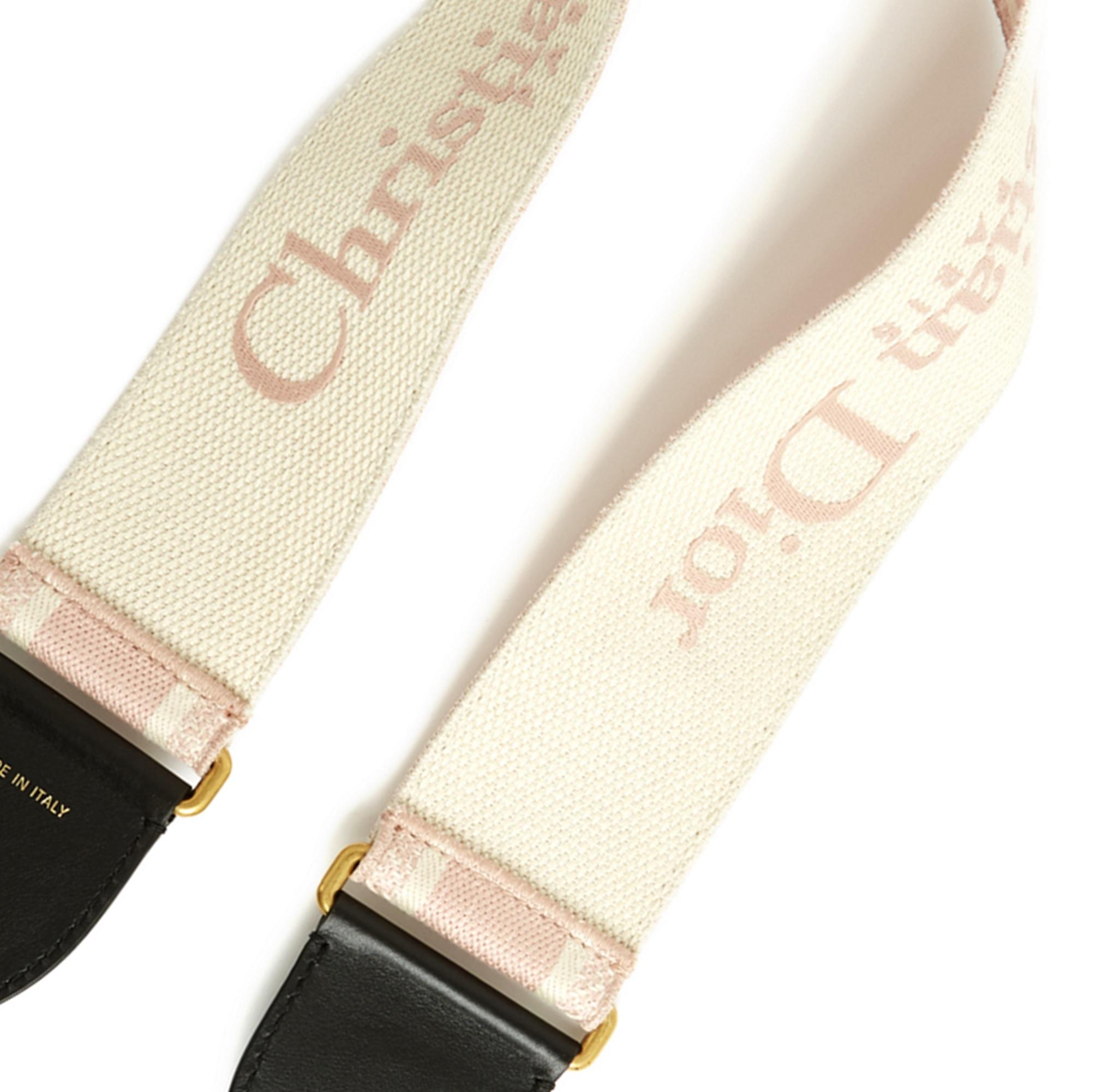 Dior shoulder strap in pink and ecru cotton strap, black leather yokes and gold metal carabiners at each end, embroidered with the Christian Dior logo on each side of the strap. Length 95cm, width 6.5cm. The shoulder strap is new with original tag,